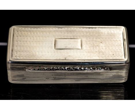 A William IV snufff box, shaped rectangular with engine turned decoration, the sides with reeded decoration, foliate thumbpie