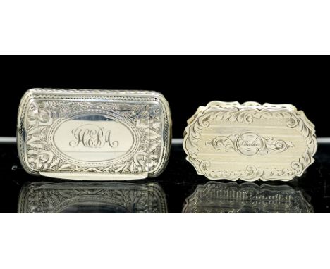 A Victorian silver snuff box, cartouche shaped with wavy rim, the entire chased and bright-cut engraved scrolling foliage and