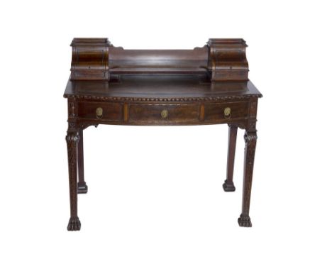 A 19th Century mahogany writing table, in the style of Thomas Hope, heavily carved with acanthus scrolls and egg and dart bor