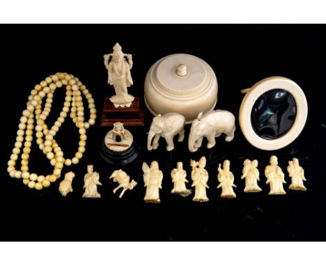 A parcel of antique worked ivory, to include a covered powder vessel, an easel photograph frame, carved figures and a bead ne