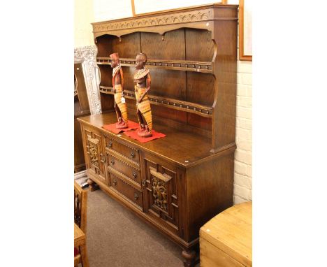 Oak shelf back dresser with armorial panelled doors, draw leaf dining table and four chairs (6)