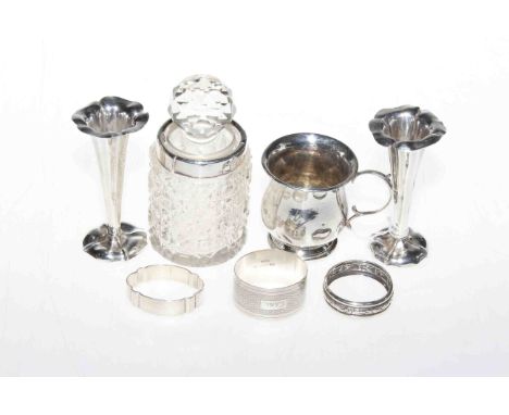 Silver christening mug, three napkin rings, pair spill vases and crystal toilet jar (7)