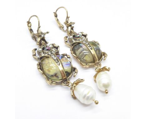 A pair of pearl drop beetle earrings
