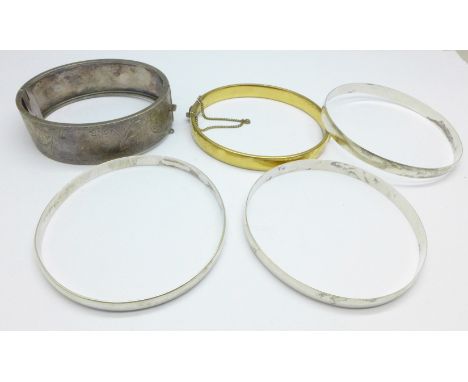 Four silver bangles, 48.9g and a metal core bangle