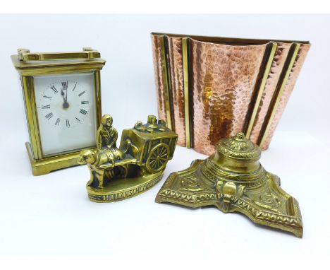 A French carriage clock, a hammered copper wall pocket, an inkwell and a brass figure, (4)