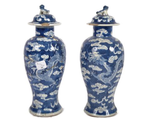 A pair of 19th Century Chinese Kangxi mark blue &amp; white porcelain vases and covers. Foo dog finial tops with meiping shap