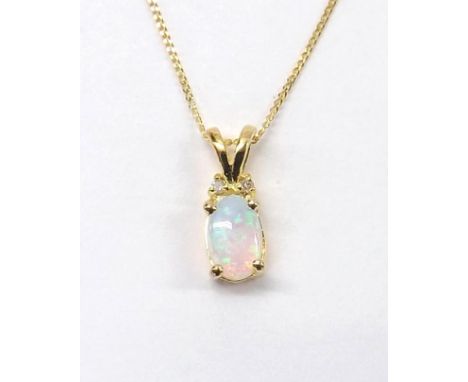 Opal and diamond 9ct pendant on a slender chain, pendant 11mm