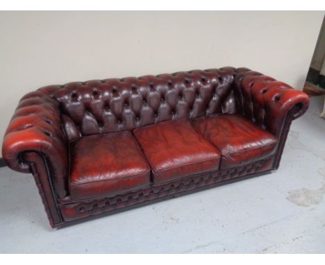 A three seater red button leather Chesterfield club settee  CONDITION REPORT: Leather with typical wrinkling, as well as some