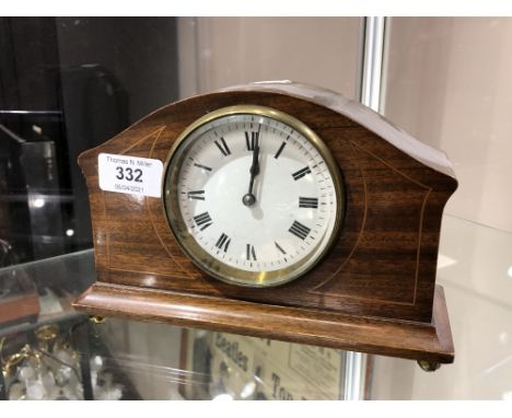 An early 20th century French inlaid mahogany mantel clock on raised brass feet 