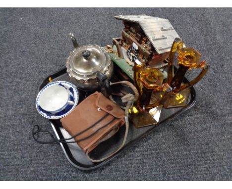 A tray of pair of amber glass Art Deco candlesticks, cloisonne finger bowl, cuckoo clock, plated teapot etc 