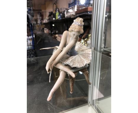 A Lladro figure of a ballerina seated on stool 