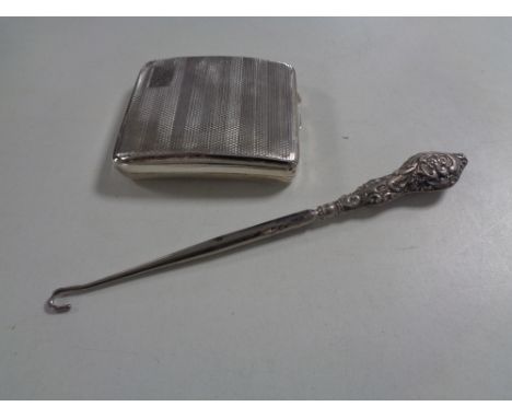 A Birmingham silver cigarette case, hall marks rubbed and a silver handled button hook. 