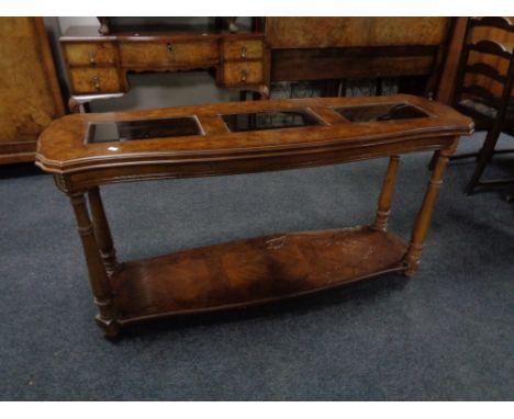 A contemporary two tier console table with three glass inset panels in a walnut finish 