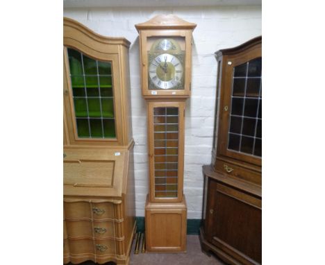 A blond oak Tempus Fugit longcase clock with pendulum and weights 