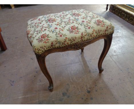 A 20th century French style beech dressing table stool upholstered in a floral tapestry fabric 