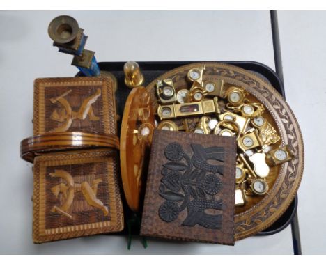 A tray of a collection of miniature brass desk clocks, wooden tourist pates, trinket box and sewing box, antique brass and bl