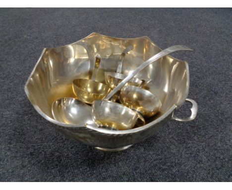 A silver plated punch bowl and ladle plus four cups 