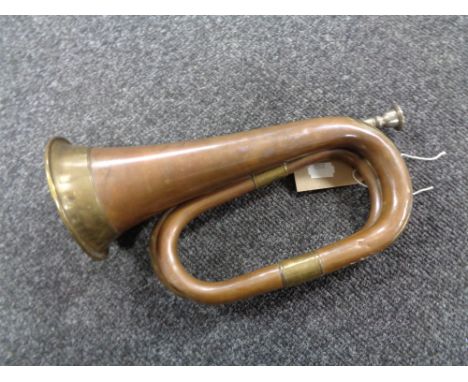 An antique brass and copper bugle 