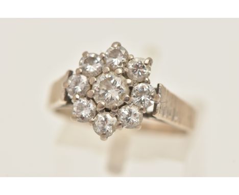 AN 18CT WHITE GOLD DIAMOND CLUSTER RING, circular cluster set with nine round brilliant cut diamonds, central diamond approxi