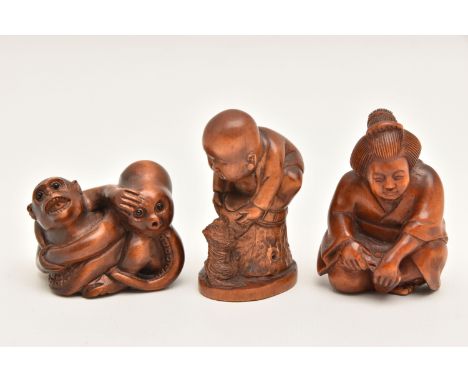AN ASSORTMENT OF NETSUKE, three carved netsuke, depicting a person and a dog, a monkey and squid, a person, all with the same