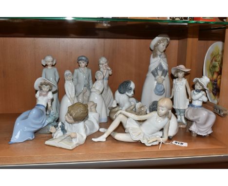 A GROUP OF MOSTLY NAO FIGURINES to include two pairs of playful dogs, a ballerina, a boy reading, a girl with a bird (chip to