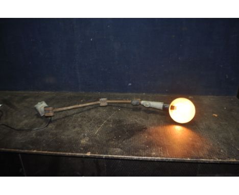 AN EARLY 20th CENTURY ARTICULATED INDUSTRIAL LAMP, with three joints, switch and modern cable and plug (PAT pass and working)