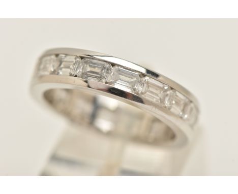 A DIAMOND FULL ETERNITY RING, designed as sixteen emerald cut diamonds channel set in white metal, approximate total carat we