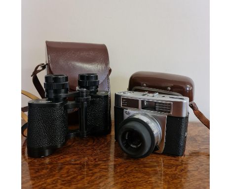A Zeiss Ikon camera in case with a pair of Zeiss Jena Jenoptem binoculars in case. Important: Online viewing and bidding only