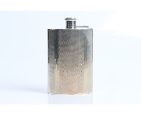 A silver engine turned hip flask with marks for Birmingham 1949 and Dudley Russel Howitt. Approx. dimensions 13.5cm x 8.5cm x