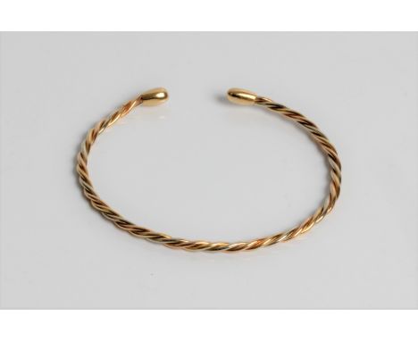 A yellow gold twist design torque bangle, marked 18ct gold, approx. 7.5gms. Important: Online viewing and bidding only. No in