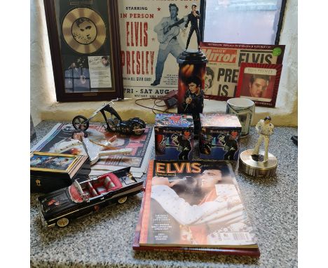 A collection of Elvis Presley memorabilia including Bradford Exchange figure on podium light, model Cadillac, newspaper, fram