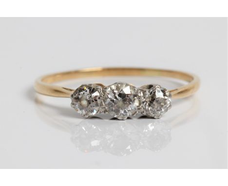 A three stone diamond yellow gold ring, marked 18ct and platinum, total diamonds 0.50 cts. ring size R 1/2, approx. weight 2.