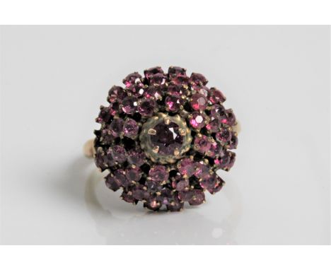 A yellow gold tiered pink sapphire cluster ring, marked 14k, ring size K, approx. weight 5.1gms. Important: Online viewing an