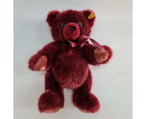 A Steiff 012983 burgundy teddy bear wearing bow. Important: Online viewing and bidding only. No in person collections, an add