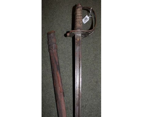 Dress sword in scabbard with engraved decoration to blade and military badge to hilt