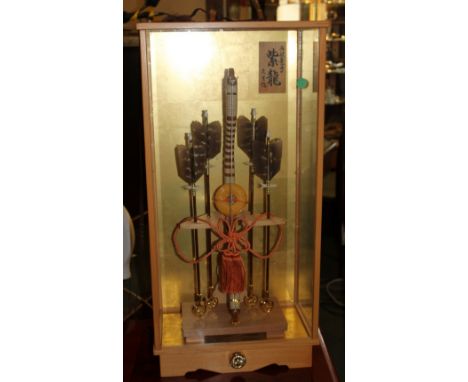 Cased Japanese bow and arrow artwork with artists signature, 72 x 36cm