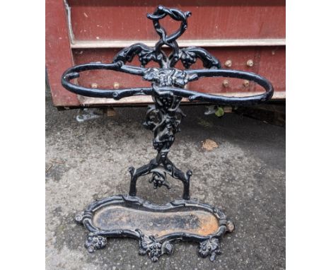 A Victorian cast iron stick stand, fashioned as entwined branches with grapes and having a drip tray below, 62cm h x 47cm w, 