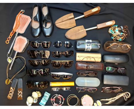 A quantity of fashion and prescription sunglasses to include a Police prescription example, an empty Paul Smith glasses case,