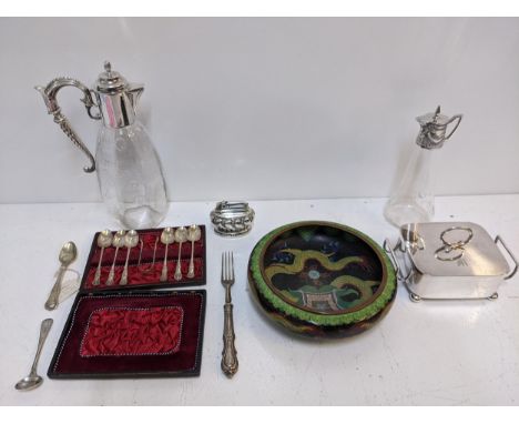 A mixed lot to include two glass jugs with silver plated tops, a table lighter, a boxed silver plated teaspoon, sugar tong se
