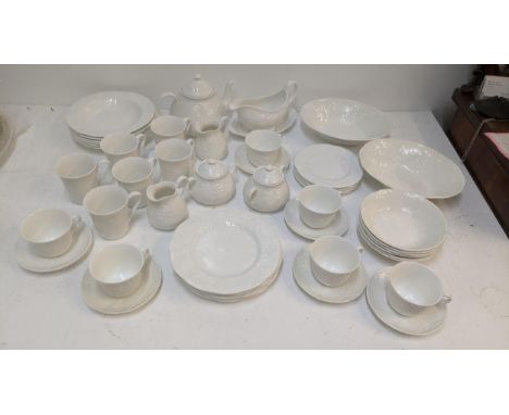 A Wedgwood Strawberry and Vine pattern part tea/dinner service to include a tea pot, sauce boat, two serving dishes, sugar bo