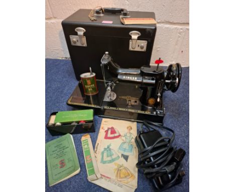A 1950's Singer 221K electric sewing machine in original fitted case with accessories and manual, serial no:EK2097077, spool 