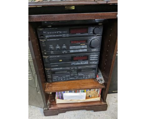 A Home stereo system in a glass fronted cabinet to include a Technics SL-J110R turntable, a ST-X301 L stereo tuner, a SU-X301