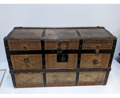 A late 19th/early 20th century leather clad oak and metal banded domed top trunk Location: GRIf there is no condition report 