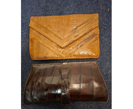 Two mid 20th Century reptile clutch bags comprising a F.Stuart Apps brown crocodile clutch approx 28cm wide and a light brown