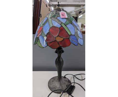 A table lamp with a cast metal base and bulbous stem with a Tiffany style shade, no plugLocation:If there is no condition rep