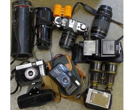 A Canon AE-1 film camera, three lenses, a pair of field glasses and other cameras