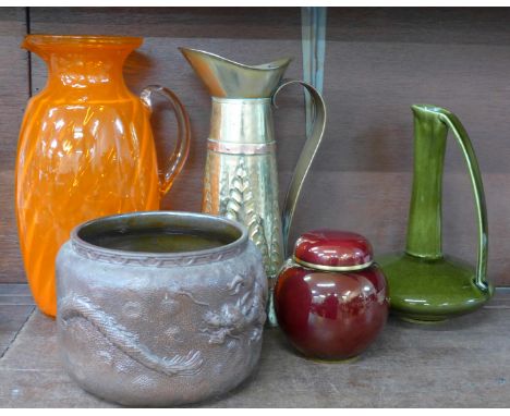 A Bretby Delhi Ware planter decorated with oriental dragons, a large orange glass vase, two jugs including brass and a Carlto