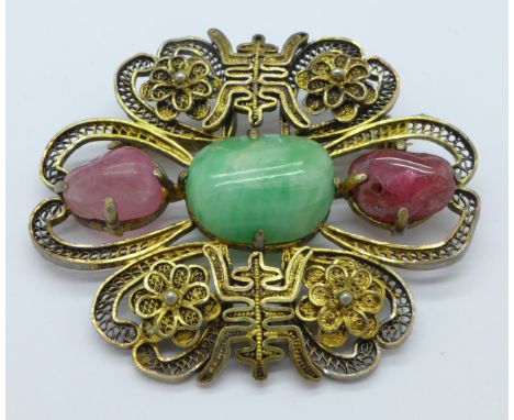 A Chinese silver gilt, ruby and jade brooch, 50mm x 41mm