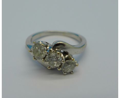 An 18ct white gold and three stone diamond crossover ring, approximately 1 carat diamond weight, 5.1g, K