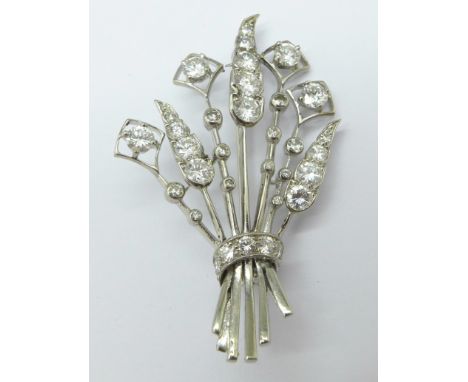 A white gold and diamond set Cartier spray brooch, set with thirty-two brilliant cut diamonds, signed Cartier and marked whit